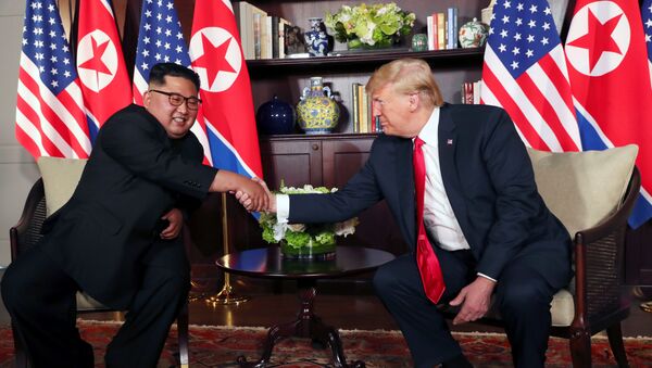 U.S. President Donald Trump shakes hands with North Korea's leader Kim Jong Un before their bilateral meeting at the Capella Hotel on Sentosa island in Singapore June 12, 2018. - Sputnik Việt Nam