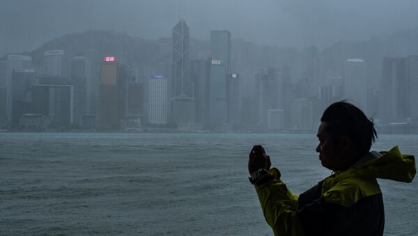 Một người ở Hồng Kông đứng chụp ảnh trước khi siêu bão Mangkhut đổ bộ - Sputnik Việt Nam
