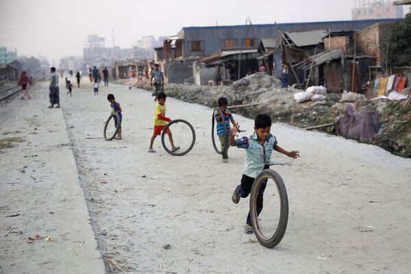 Trẻ em chơi với lốp xe trên đường phố Dhaka, Bangladesh - Sputnik Việt Nam