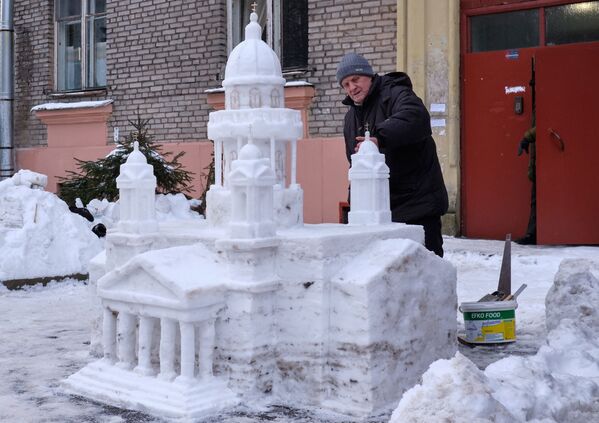 Họa sĩ Vladimir Kuzmin, người đã xây dựng Nhà thờ lớn St. Isaac bằng tuyết trong sân nhà của mình ở quận Primorsky, St. Petersburg - Sputnik Việt Nam