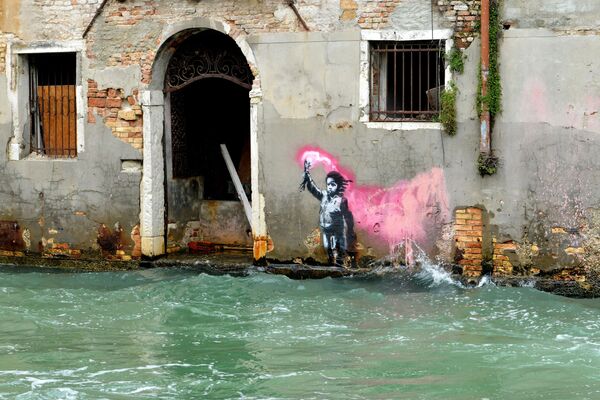 Có lẽ là tác phẩm của nghệ sĩ đường phố người Anh Banksy ở Venice, mô tả một đứa trẻ di cư trong chiếc áo phao phản quang màu hồng - Sputnik Việt Nam