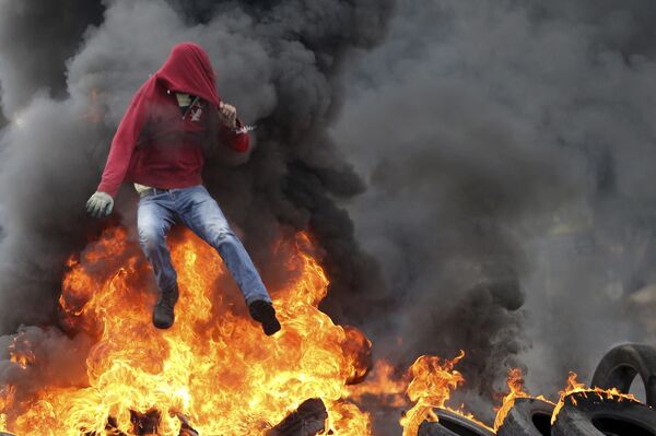 Một người biểu tình trong cuộc đụng độ ở thành phố Ramallah của Palestine, gần Jerusalem. - Sputnik Việt Nam