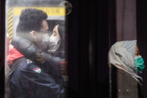 Cặp đôi đeo khẩu trang hôn nhau trong tàu điện ngầm Hồng Kông - Sputnik Việt Nam