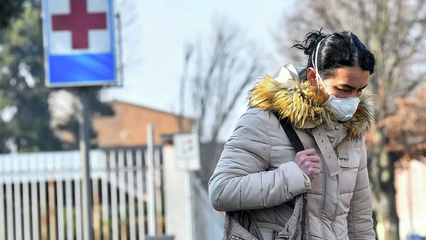 Một người phụ nữ đeo mặt nạ bảo vệ rời bệnh viện Codogno ở miền bắc Italy. - Sputnik Việt Nam