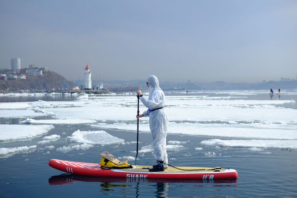 Vận động viên ván chèo trong bộ đồ bảo hộ ở vịnh Vladivostok - Sputnik Việt Nam