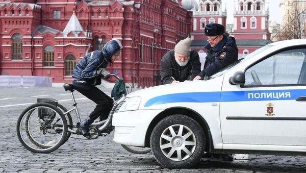 Сотрудник полиции во время проверки соблюдения горожанами режима самоизоляции на Красной площади в Москве - Sputnik Việt Nam