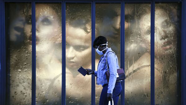 Người phụ nữ đeo khẩu trang y tế trên nền cửa kính cửa hàng ở Paris, Pháp - Sputnik Việt Nam