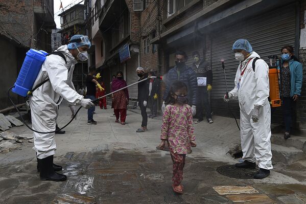 Nhân viên y tế phun thuốc khử trùng lên bé gái ở Kathmandu, Nepal - Sputnik Việt Nam