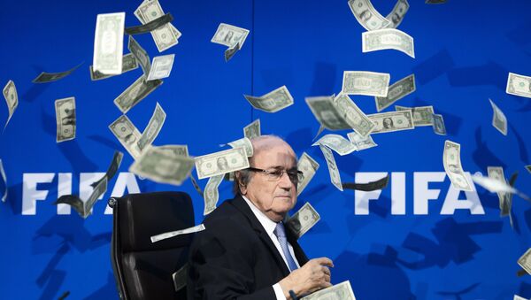 Chủ tịch FIFA Joseph Blatter nhìn những đồng đô la giả mà những người biểu tình ném xuống trong cuộc họp báo tại trụ sở ở Zurich - Sputnik Việt Nam